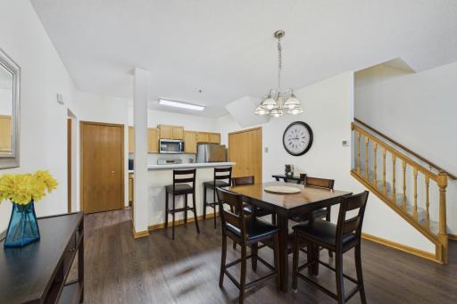 Dining area with updated lighting, open layout, and easy access to kitchen and living spacesâideal for everyday living and entertaining.