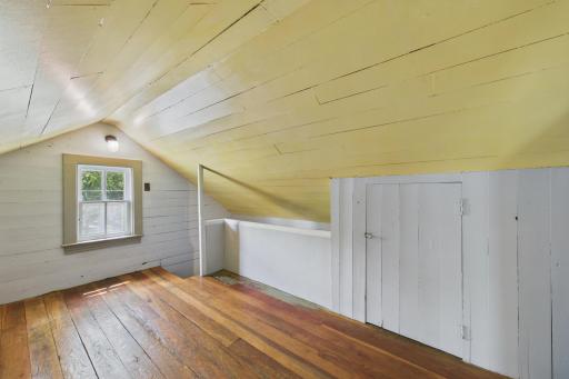 Additional staircase from the kitchen to the upper level adds charm and functional flow to the home.