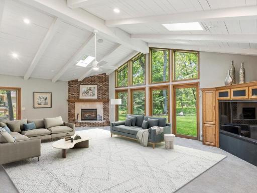 Vaulted family room with skylights, gas fireplace, sliding door to deck.