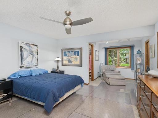 Main floor primary bedroom with sitting area and two walk in closets.