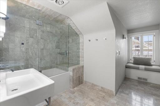 A luxurious bathroom with heated flooring on the third level