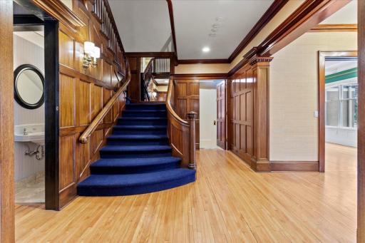 Stunning grand staircase accented by meticulous mahogany woodwork and elegant detailing