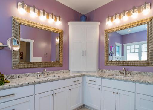 Separate sinks in the primary bathroom. Ideal for two, there are also TWO walk-in closets in this suite!