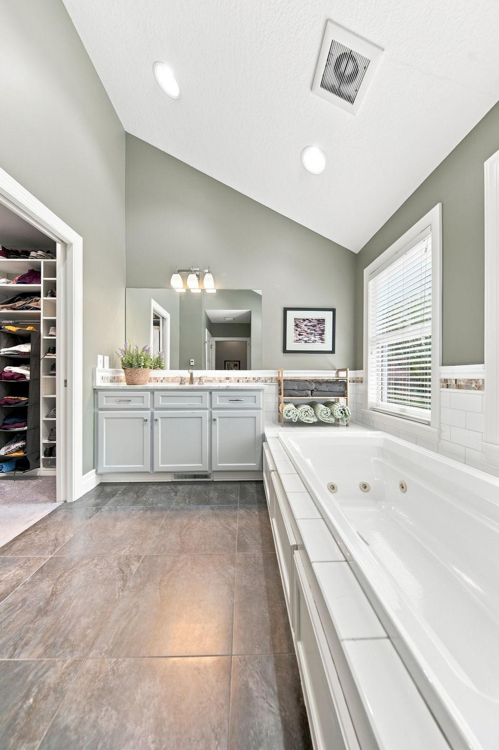 Bathroom features a tub, shower and walk-in closet