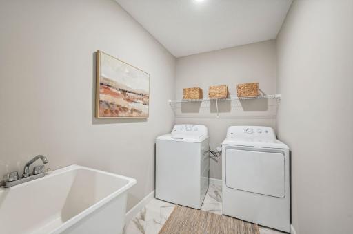 Main Floor Laundry Room - photo of a staged model home of the same floorplan. Selections may be different.