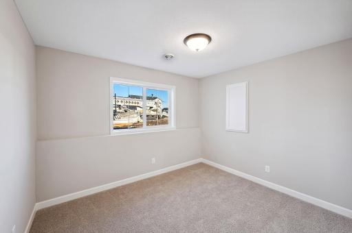 Lower Level Bedroom - photo of a staged model home of the same floorplan. Selections may be different.