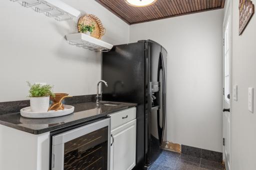 Butlers pantry offers additional storage, beverage refrigerator, built-in sink and big refrigerator. Entry door leads to the deck