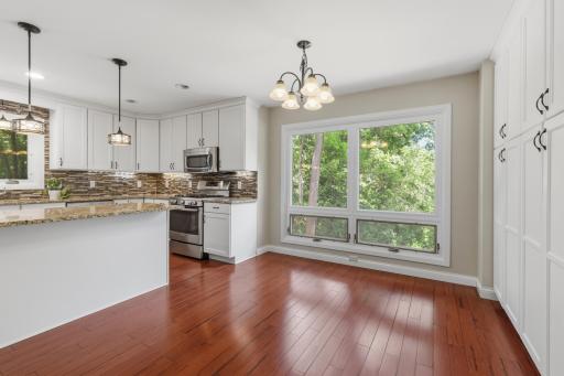 Informal dining area with full wall of cabinets