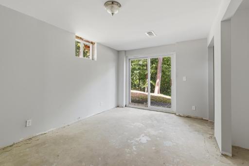 Walkout, patio door access to the naturally private lot!
