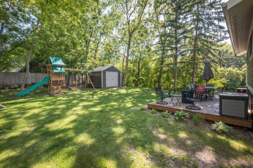 Private yard with composited maintenance free decking and storage shed.