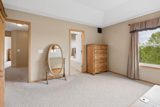 Primary bedroom is generously sized, and features a private en suite