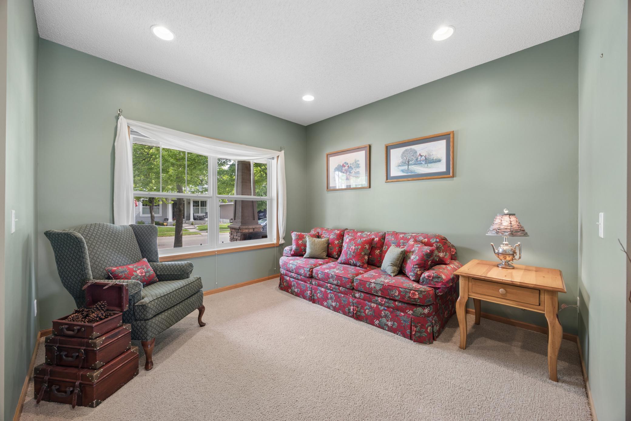 Front study/flex room has views of the charming front porch