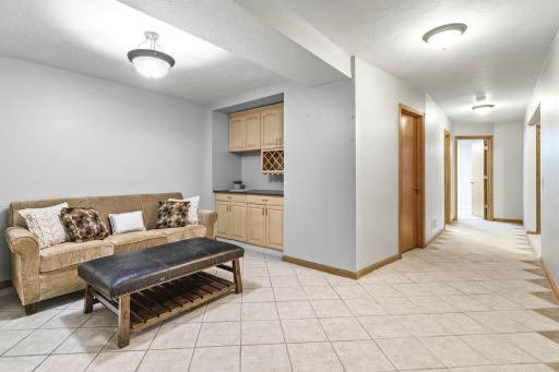 The finished lower level offers a separate entertaining space with a built-in serving area/bar, creating the perfect spot for movie nights, game days, or hosting family and friends.