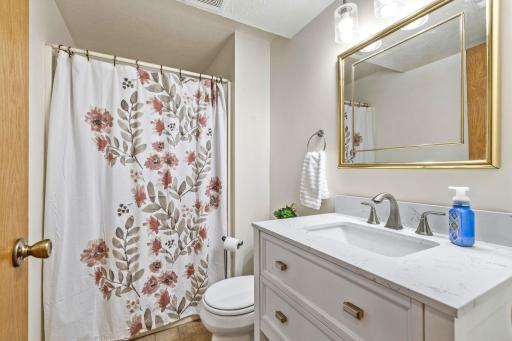 Renovated lower level 3/4 bath with tile floor.