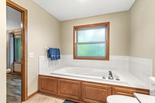 Relaxing soaking tub and walk-thru to primary bedroom.