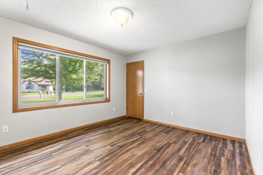 2nd bedroom on main level - freshly painted, updated flooring and walk-in closet with custom organizers by Closets By Design.