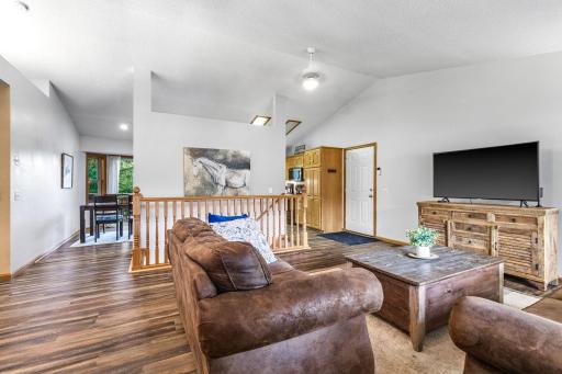 Vaulted ceilings enhance the open-concept main floor, offering an airy feel and seamless flow between the living spaces.