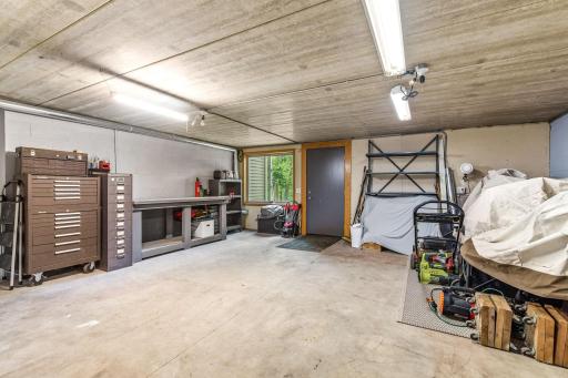 Rare spancrete storage area provides exceptional space for a workshop, hobbies, tools, lawn equipment, and organized storage - an incredible bonus for DIY enthusiasts and anyone needing extra space.