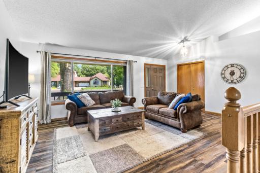 A warm and inviting main floor living room welcomes you with abundant natural light, updated flooring, and a bright, open feel.