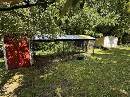 Storage shed with electricity and another view of the chicken coop.