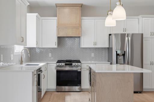 Enjoy the stainless appliances that include a slide in gas range, refrigerator, dishwasher and microwave drawer.