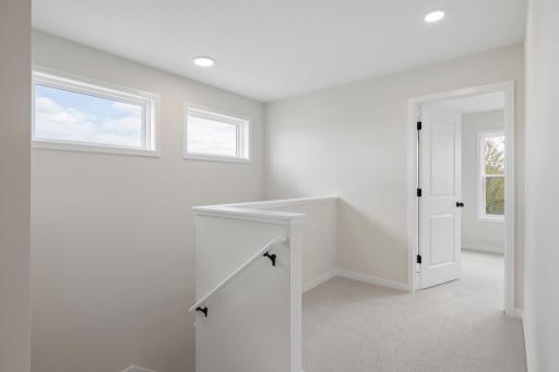 Functional upper level with room for a desk or reading nook, 3 spacious bedrooms, two well-appointed bathrooms and convenient laundry with built-in cabinetry.