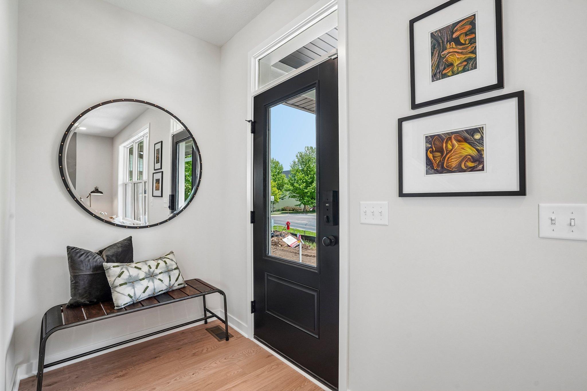 Beautiful entryway with natural light flooding in from the door.