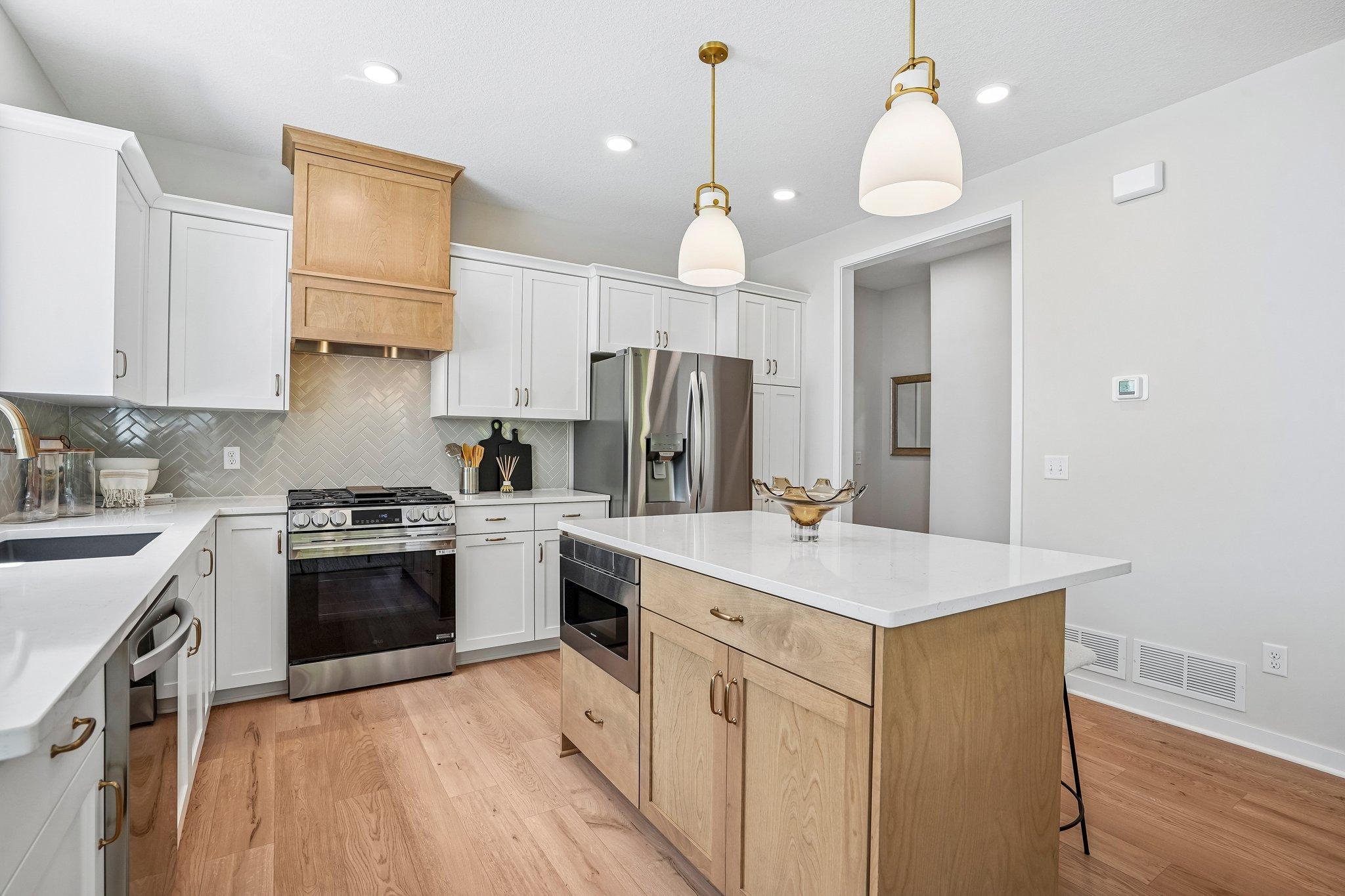 Enjoy the stainless appliances that include a slide in gas range, refrigerator, dishwasher and microwave drawer.