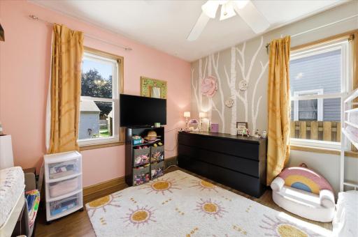 Second bedroom on main floor with decorative painting on the walls.