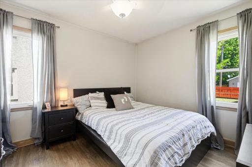 Main floor offers two bedrooms and full bath to share. Both have original hardwood floors.