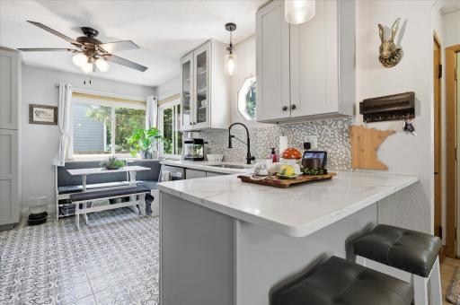 Kitchen was updated in 2019 with new cabinetry, decorative floor tile, quartz counters and stainless steel appliances.
