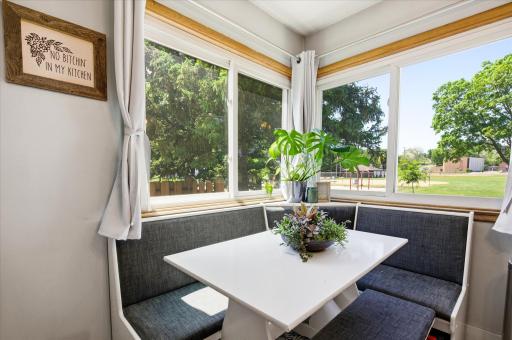 Bright sunshine coming in this corner window over the table/nook.