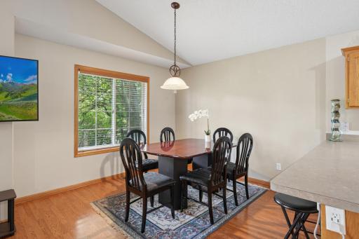 The dining area offers beautiful views of the backyard and surrounding nature, creating a peaceful setting for everyday meals and entertaining.