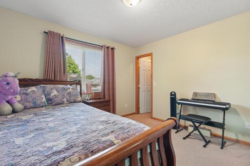 This spacious bedroom offers plenty of room for furniture and features a walk-in closet for ample storage.
