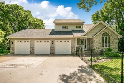 The home offers impressive curb appeal, featuring durable metal siding with attractive brick accents, architectural shingles, seamless rain gutters, and a concrete driveway.
