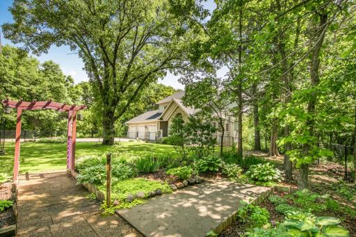 Fenced in front yard with chain-link fence that has two entrance points.