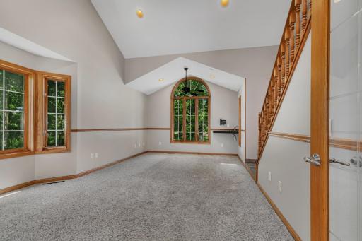 Multiple gathering spaces, including a spacious living room with a soaring vaulted ceiling and a skylight.