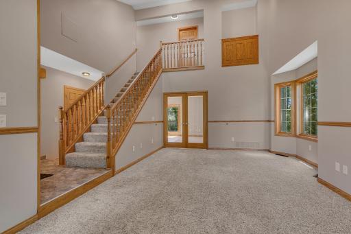 Elegant beveled-glass French doors separate the living room from the family room.