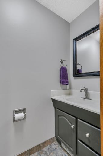 Main level half bath with tile flooring just off the front entry.