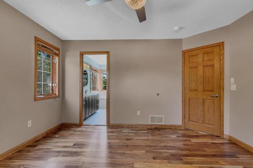 The primary suite serves as a true retreat, featuring beautiful maple hardwood floors, a ceiling fan, and a dedicated mini-split heating and cooling system (new 2023).