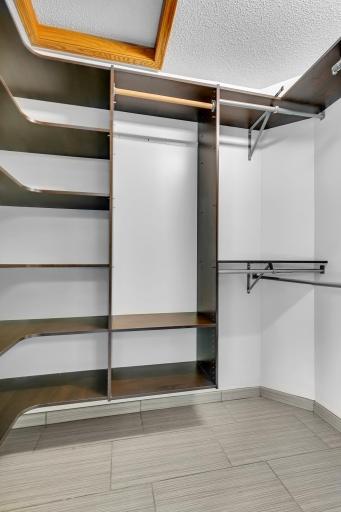 Here is the primary suiteâs walk-in closet with an organizer system.