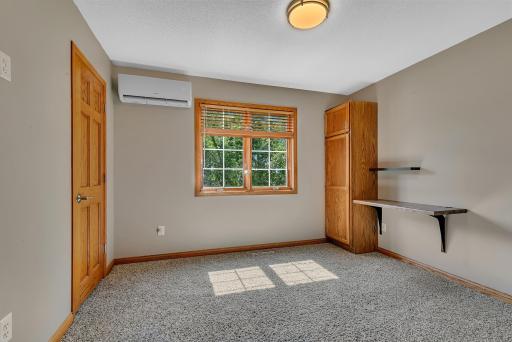 The second bedroom offers built-in cabinetry and shelving, making it equally suitable as a bedroom or home office, and includes its own Wi-Fi-enabled mini-split system (new 2023).