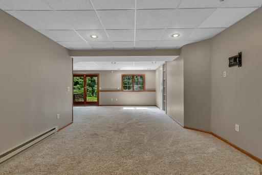 The walkout lower level provides even more living space with a large recreation room, complete with built-in shelving and cabinetry.
