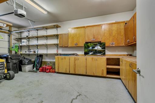 Finished third stall with built-in cabinets, shelving, and workbenches.