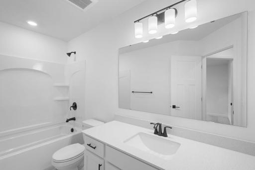 This full second-floor bathroom features a wide single vanity and shower-tub combination..jpg