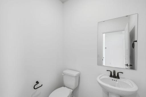 In a discreet location on the first floor is a convenient powder room to accommodate the needs of the whole household and visiting guests.