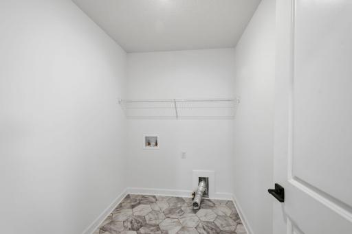 The laundry room features ventilated shelving for all your storage needs
