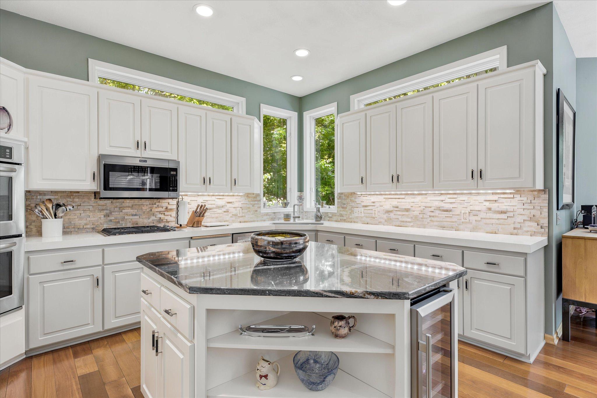 Corian Counters, Stone backsplash, Under-cabinet lighting
