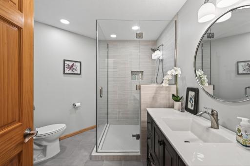 Newly renovated, this lower-level Â¾ bathroom adds both style and convenience.