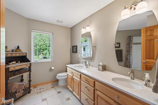 Conveniently located near the upper-level bedrooms, this full bathroom is designed to keep busy mornings running smoothly.